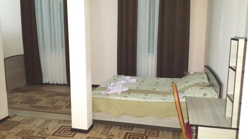 a small bedroom with a bed in a room at Mini-pansionat Maksat in Cholpon-Ata