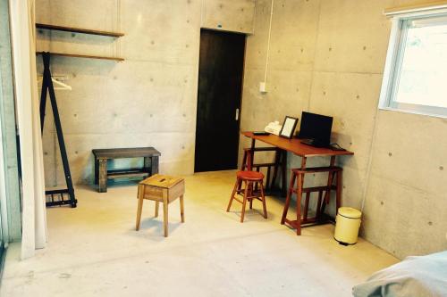 a room with a desk and two stools and a table at Retya in Ishigaki Island