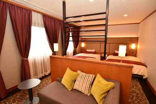 Postel nebo postele na pokoji v ubytování Hotel Sunroute Sano