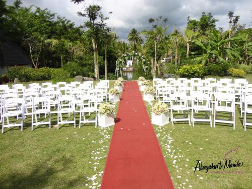 a red and white aisle with white chairs and a red carpet at Abagatan ti Manila in Alfonso