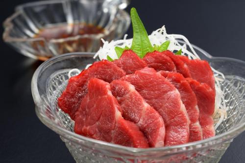 a glass bowl filled with cuts of meat at Towada City Hotel in Towada