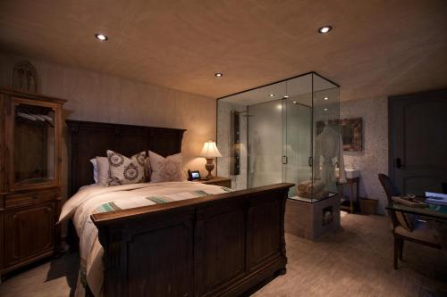 a bedroom with a large bed and a large mirror at O:Live Boutique Hotel, A Small Luxury Hotel of the World in San Juan