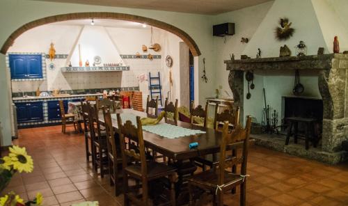 a dining room with a table and a fireplace at B&B Apricot in Policoro