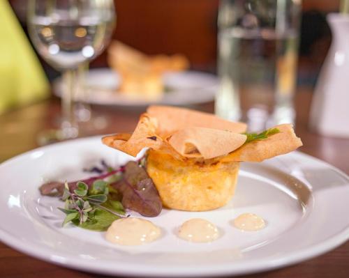 a white plate with food on a table at Best Western Gustaf Froding Hotel & Konferens in Karlstad