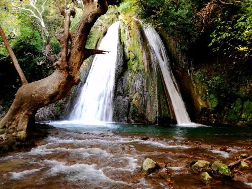 a waterfall in the middle of a river at Thermios Apollon in Thermo
