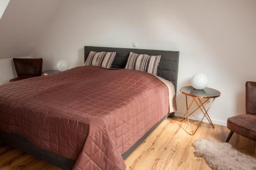 ein Schlafzimmer mit einem großen Bett und einem Stuhl in der Unterkunft Lieblingsbude Schwerin in Schwerin