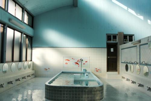 a room with a tub in the middle of a building at Guest House Kamejikan -turtle time- in Kamakura