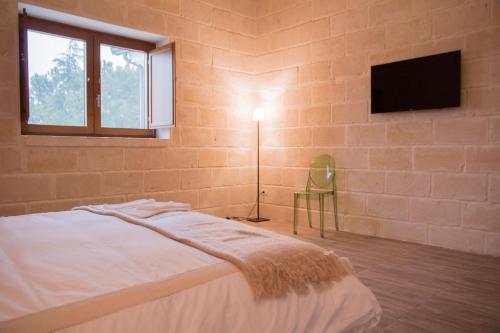Un pat sau paturi într-o cameră la Masseria Straziuso - La Vaccariccia