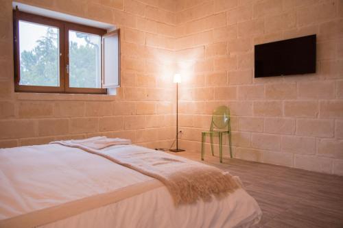 Tempat tidur dalam kamar di Masseria Straziuso - La Vaccariccia