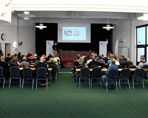 a group of people sitting at tables in a room with a presentation at Best Western Gustaf Froding Hotel & Konferens in Karlstad