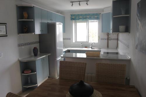 a kitchen with blue cabinets and a kitchen island at Appartement 179 in Gran Alacant