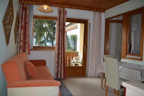 a living room with a couch and a window at Frühstückspension Blasge in Bodensdorf