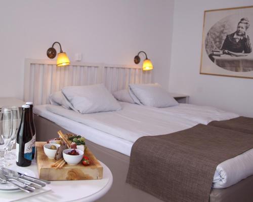 a hotel room with two beds and a tray of food at Best Western Gustaf Froding Hotel & Konferens in Karlstad