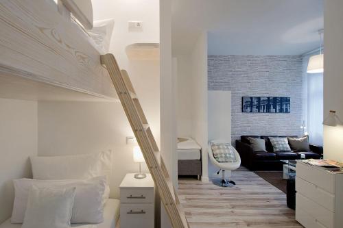 a bedroom with a loft bed and a living room at Familienstudio 27 in Berlin