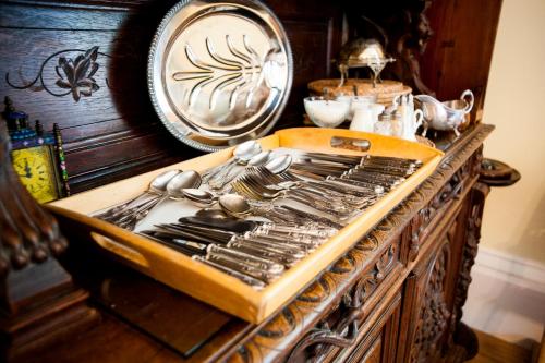 a tray of utensils sitting on top of a table at Molland Manor House Bed & Breakfast in Sandwich