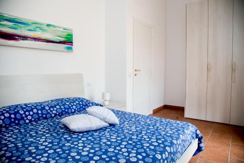 a bedroom with a blue bed with pillows on it at Rosanna House in Bombarde Beach in Alghero
