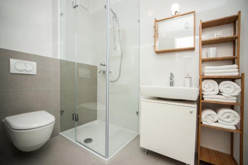 a bathroom with a shower and a toilet and a sink at Apartment Morska vila in Split