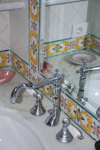 
a sink and mirror in a bathroom at Casa Angelica Positano in Positano

