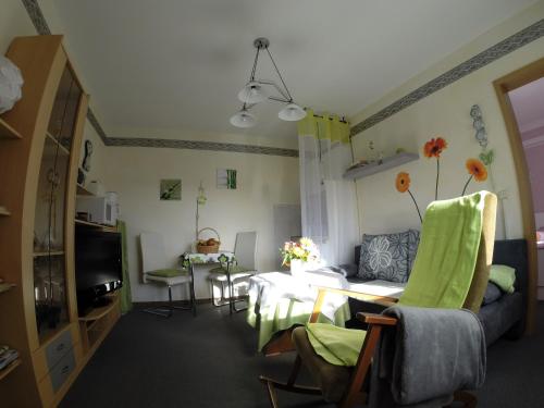 a living room with a table and a couch at Ferienwohnung Ritter in Schmiedefeld am Rennsteig