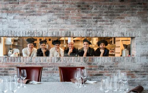 a group of men standing behind a brick wall at Devero Hotel & Spa, BW Signature Collection in Cavenago di Brianza