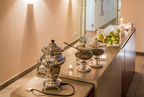 a counter with a table with food and fruit on it at Devero Hotel & Spa, BW Signature Collection in Cavenago di Brianza