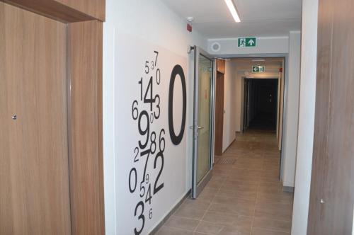 a hallway with a wall with writing on the wall at Apartament z Ogrodem Gdansk Przymorze in Gdańsk
