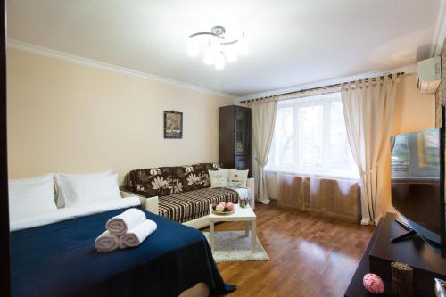 モスクワにあるLux Apartments Мытная 24のリビングルーム(ベッド1台、ソファ付)