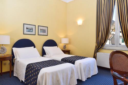 Postel nebo postele na pokoji v ubytování Hotel Firenze e Continentale