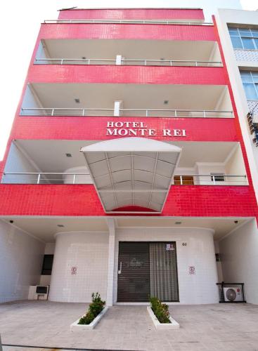 a red building with a sign that reads hotel monkey red at Hotel Monte Rei in Salvador