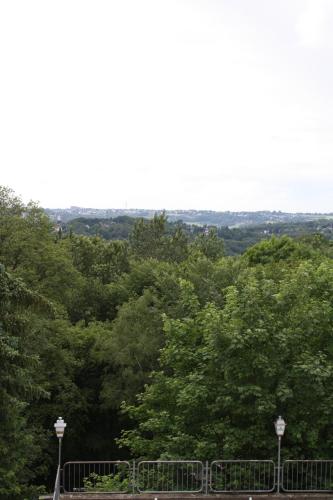 a park with a fence and trees in the background at Hotel König in Remscheid