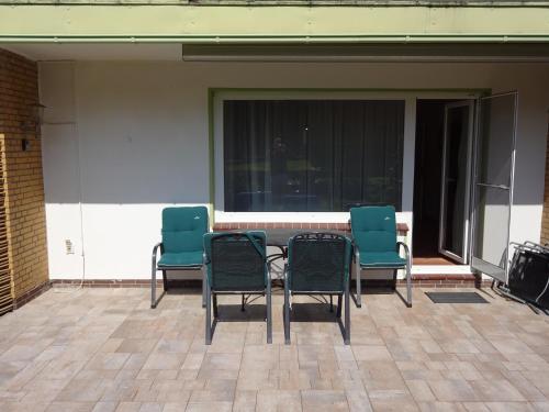 a group of chairs sitting around a table on a patio at Strandleben 4 in Grömitz