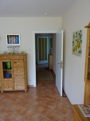 a hallway with a room with a dresser and a door at Strandleben 4 in Grömitz