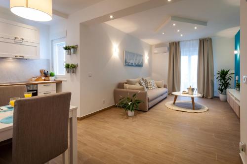a living room with a couch and a table at Sunny Garden Lux in Split