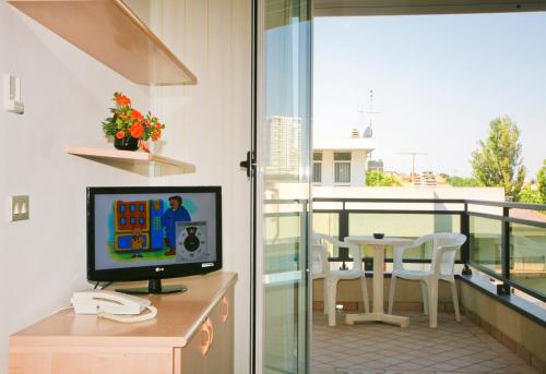 a room with a desk with a computer on a balcony at Residence le Spiagge in Rimini