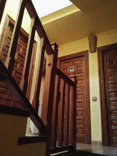 a hallway with wooden doors in a house at Casa Rural Celtia in Aguilar del Río Alhama