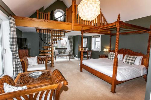 a bedroom with a canopy bed and a living room at Butt Lodge in Lochranza