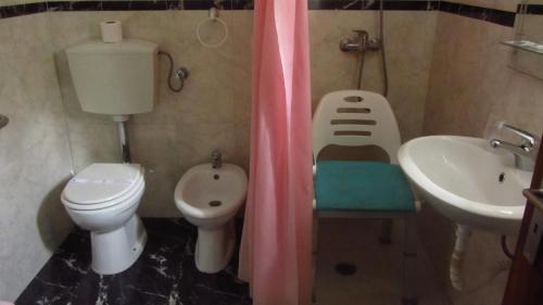 a small bathroom with a toilet and a sink at Residencial Martinho in Lousã