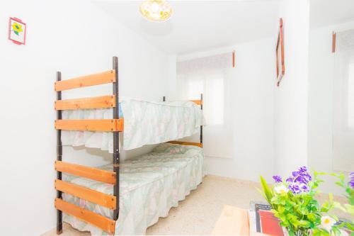 a bedroom with a bunk bed in a room at Apartamentos Giralda in Chiclana de la Frontera