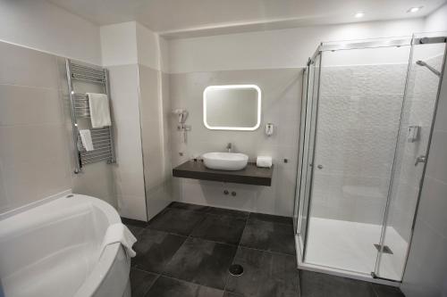 a bathroom with a toilet and a sink and a shower at Hotel Santa Cruz in Cangas de Onís