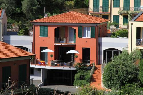a house with a balcony in a city at Baia Blu RTA Residence in Lerici