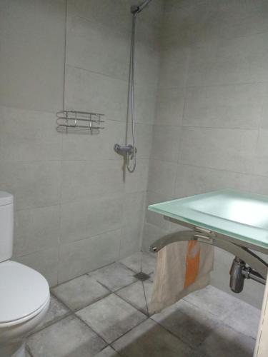 a bathroom with a shower with a toilet and a sink at SB Arenal in El Arenal