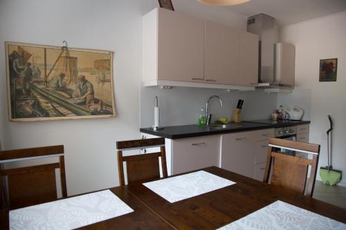 a kitchen with a table and a painting on the wall at Holiday home in Kuusankoski in Kuusankoski