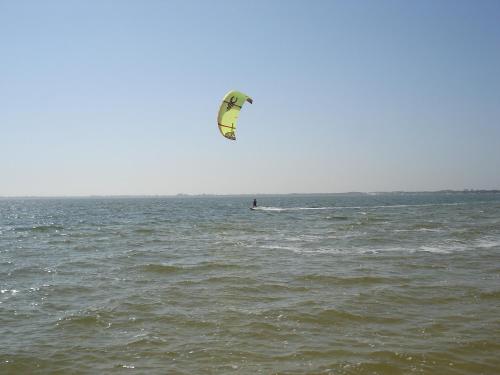 a person is kite surfing in the ocean at Villaggio dos Ventos in Arraial do Cabo