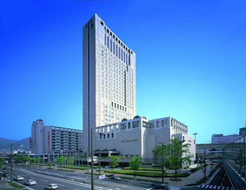 a tall building in a city with a highway at Rihga Royal Hotel Kokura Fukuoka in Kitakyushu