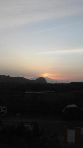 a sunset with the sun setting in the distance at Cote de France in Fundura