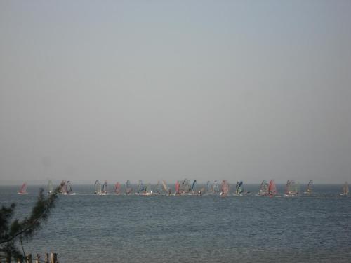 a large group of boats in the water at Villaggio dos Ventos in Arraial do Cabo