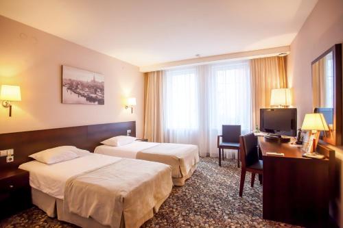 Ένα ή περισσότερα κρεβάτια σε δωμάτιο στο Kaiserhof Hotel