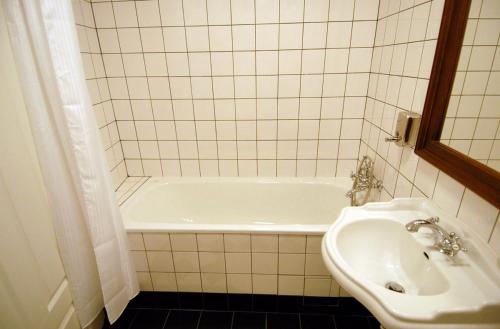 a bathroom with a white tub and a sink at Pivovar Hotel Na Rychtě in Ústí nad Labem