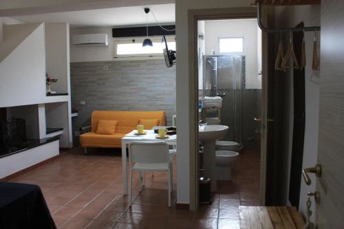 a bathroom with a sink and a toilet and a table at La Macchia in Melendugno