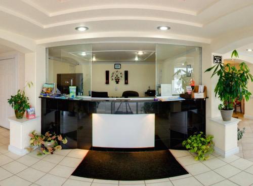 an office with a reception desk with plants at Key West Inn - Newport News in Newport News